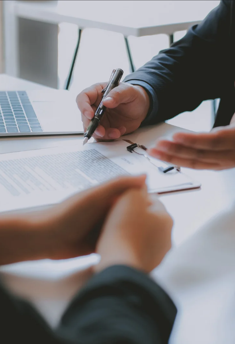 Two people reviewing a document on a clipboard