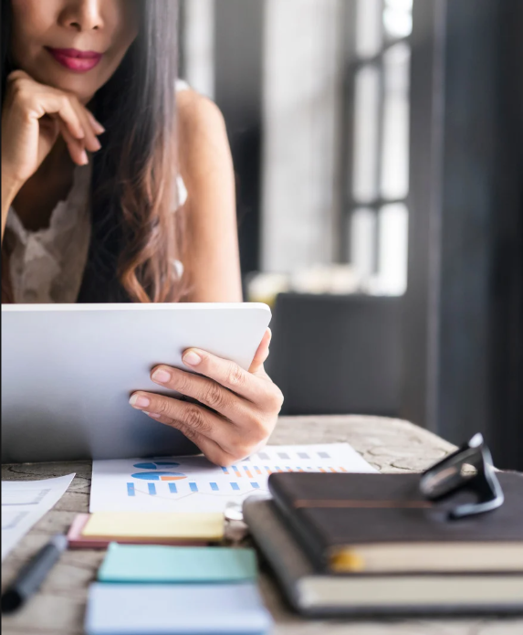 Woman at desk with papers and clipboard